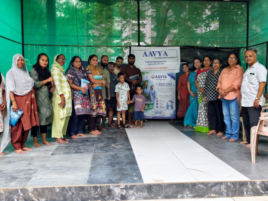 Distributing rain coats to community workers